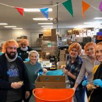 Alumni sort food into boxes at Kids' Food Basket